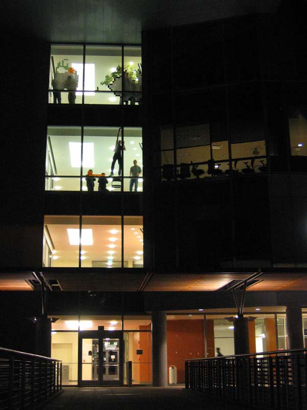 The building at night as the installation goes up, frame 1 of 12