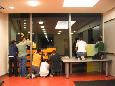 The crew assembling sprites on the floor indoors